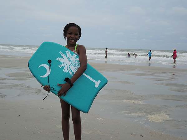 Girl with Board at Beach